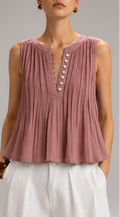 A sleeveless pleated top in dusty mauve pink, shown in multiple views on a model. The top features a split neckline with decorative buttons down the center front and on the left shoulder.